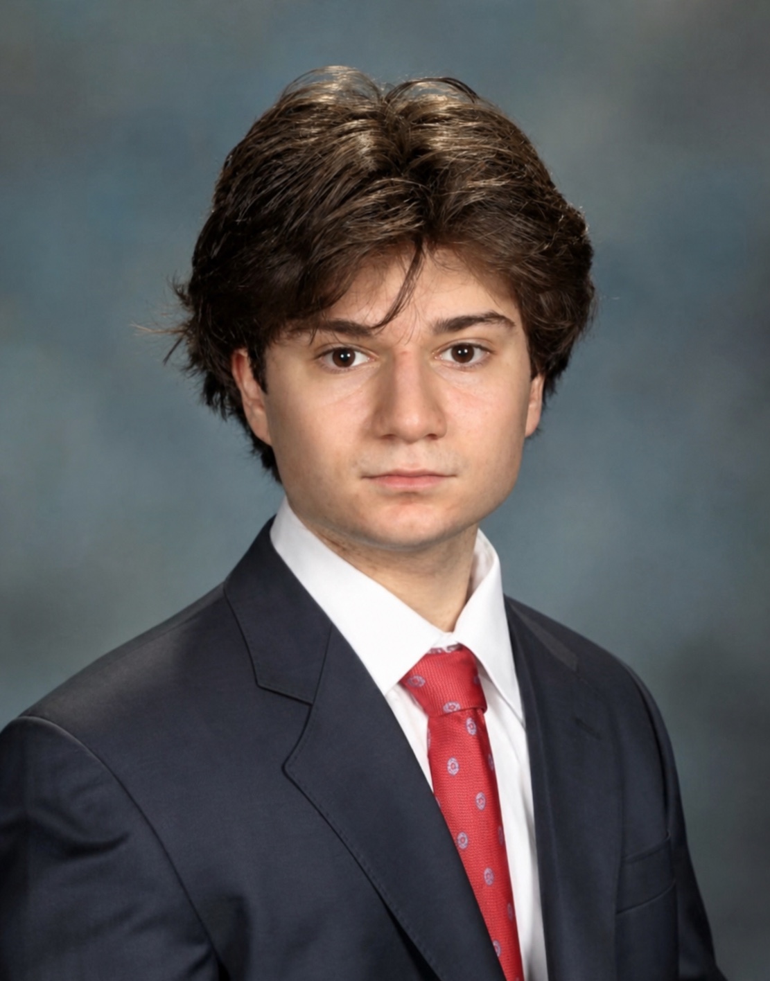 Portrait of Matthew Wool in a suit and red tie