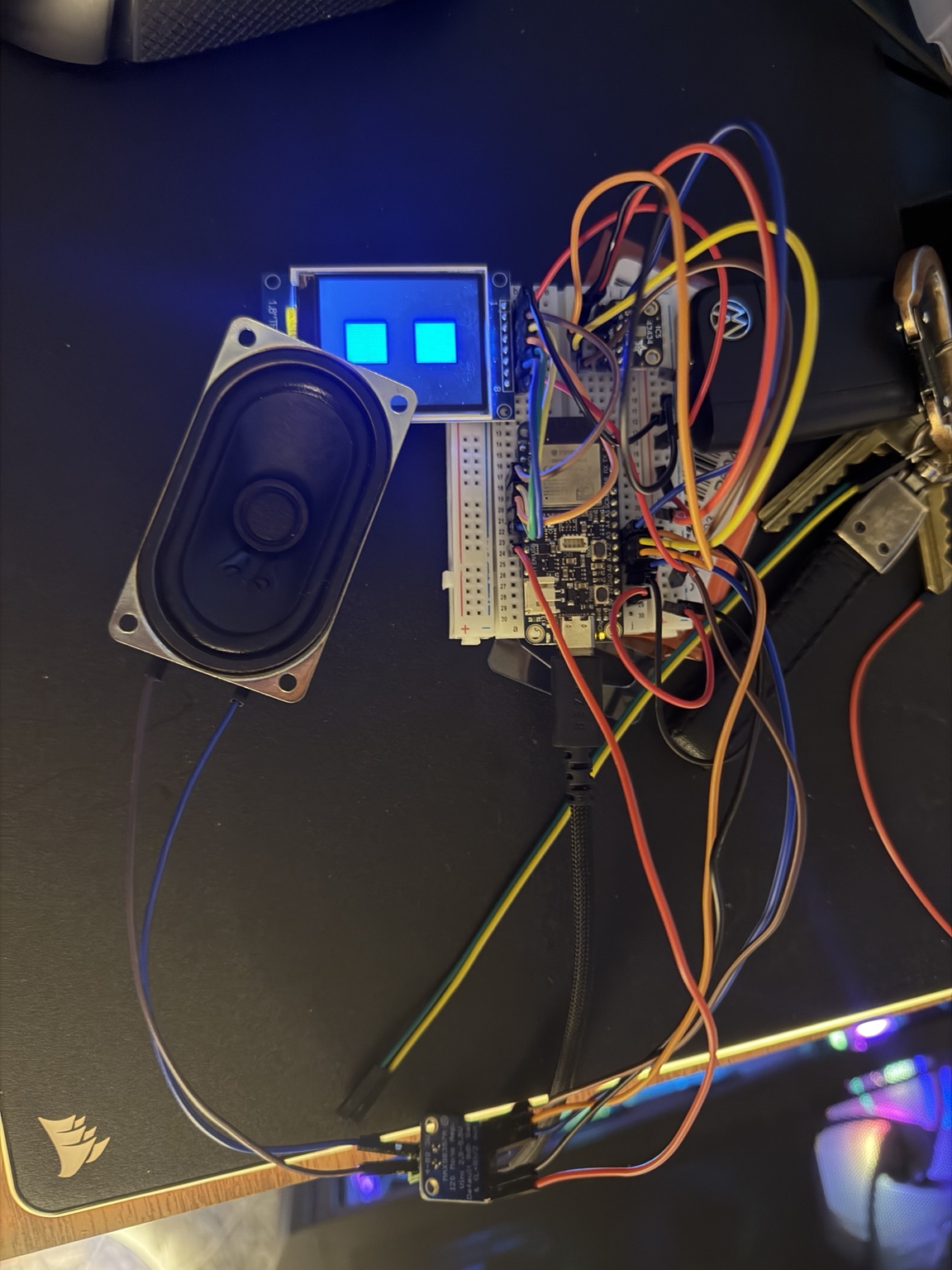 Pip prototype with glowing blue eyes, ESP32 hardware, a speaker, and breadboard wiring